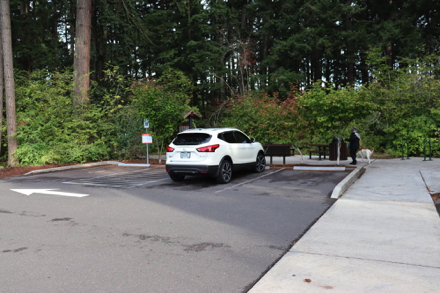 Parking area with trash can, picnic tables, bike rack, kiosk and bench Parking area with trash can, picnic tables, bike rack, kiosk and bench